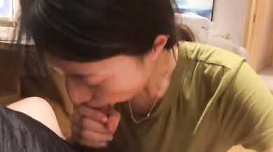 Woman in Blue Dress Kneels to Pleasure Boyfriend