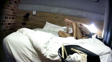 College student couple takes selfies on hotel date