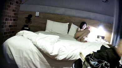 College student couple takes selfies on hotel date