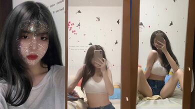 Sexy girl with breast tattoos in front of mirror